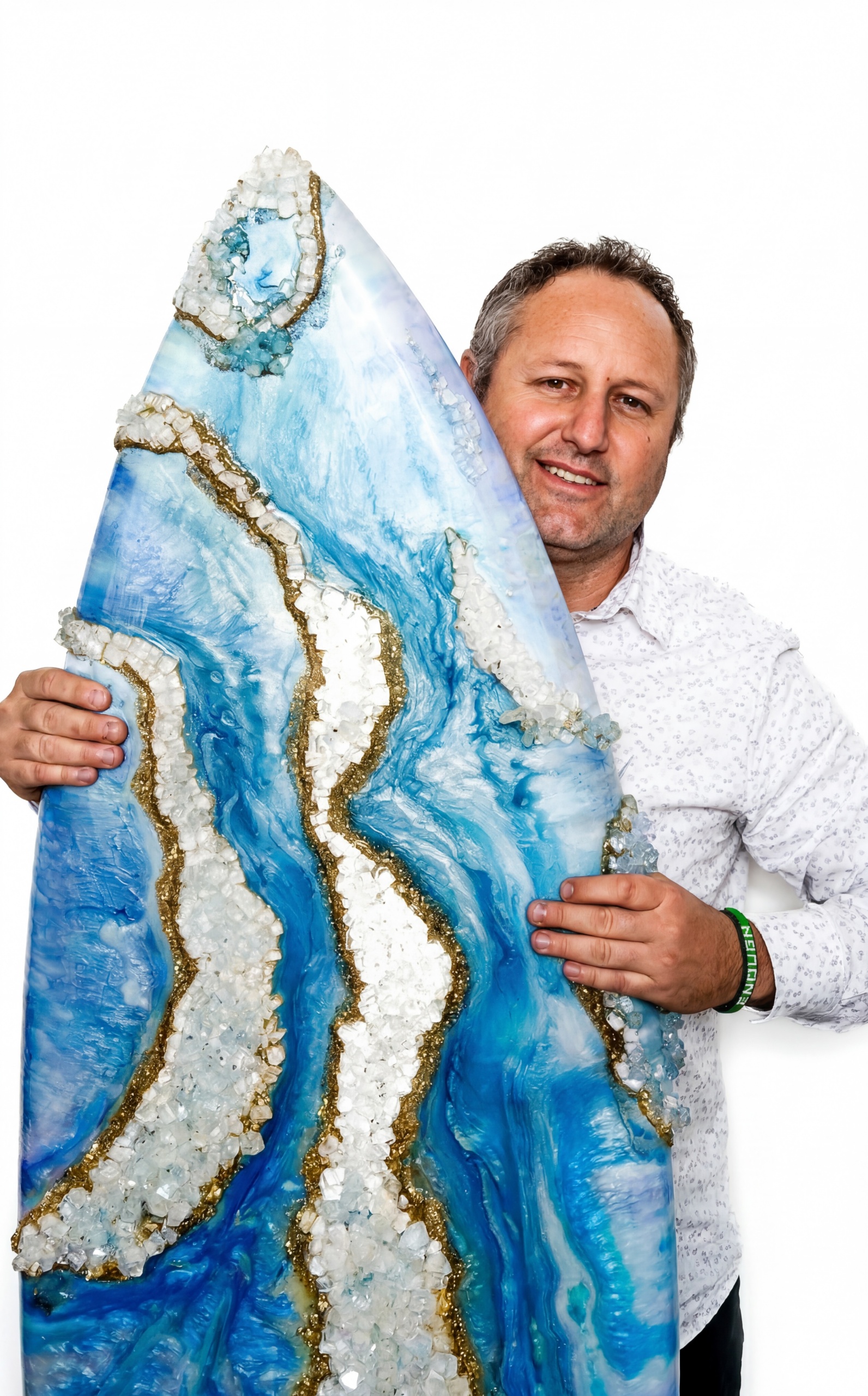 josh ducharme holding an epoxy resin geode inspired surfboard artpiece